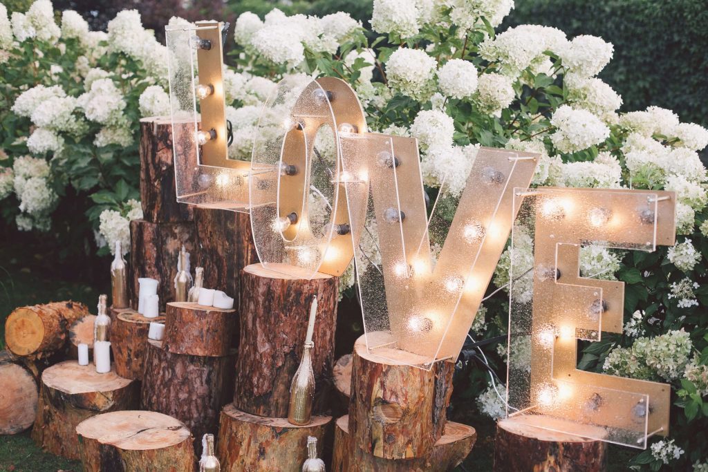 "Love" text on table surrounded by flowers.